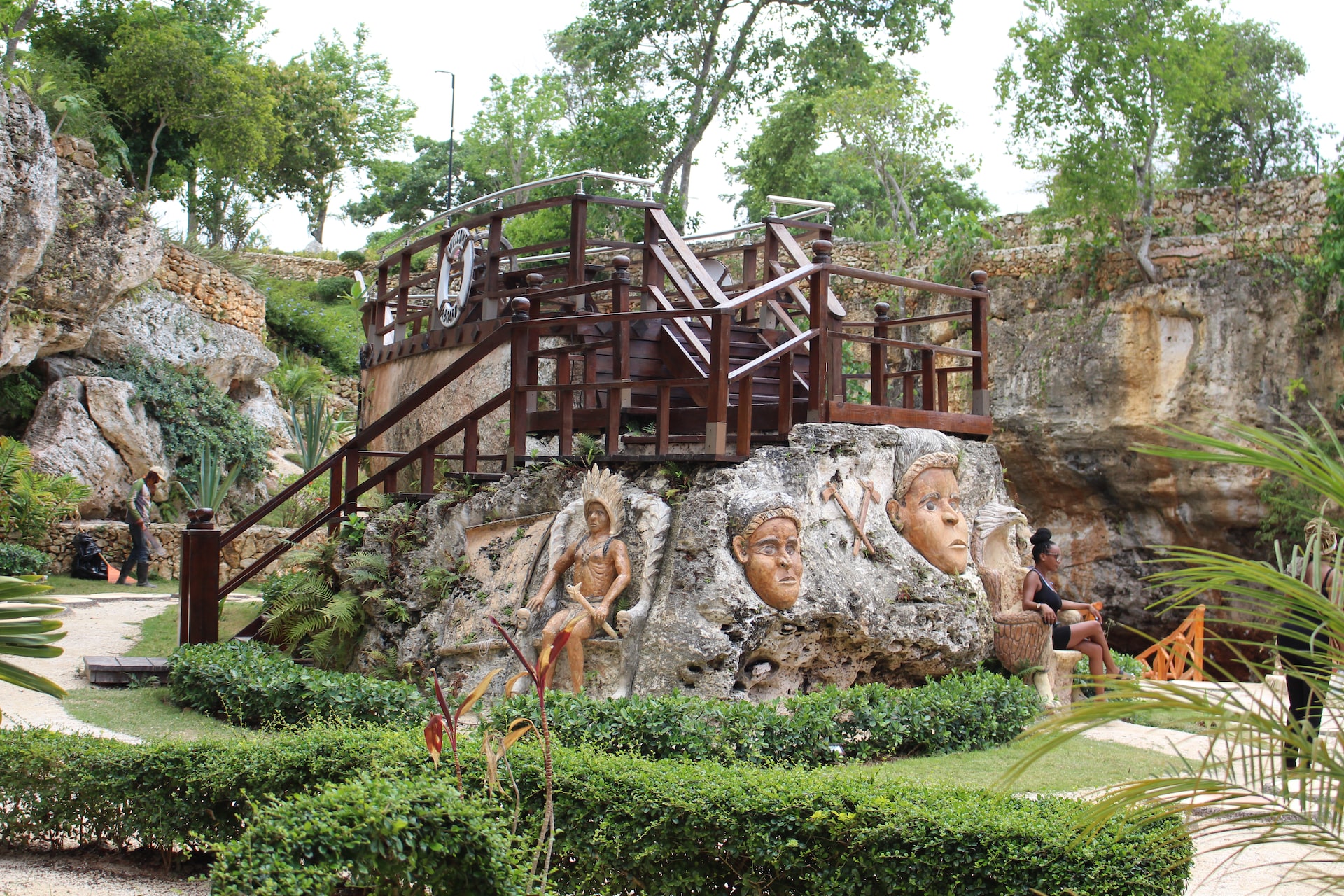 a large rock with a painting of people on it